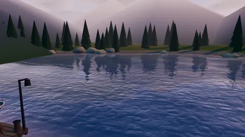 A still lake below misty mountains and pine trees, with a lamp post on the jetty.